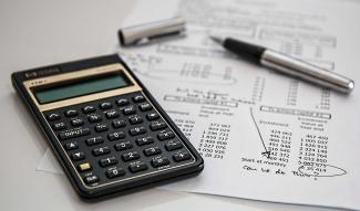 Calculator and worksheets on desk