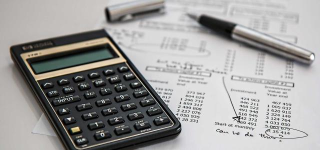 Calculator and worksheets on desk